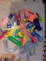 pile of assorted Hot Wheels track components and accessories