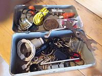 Overall view of open metal box and contents