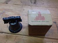 Bell next to box front displaying Independence Hall graphic and product text