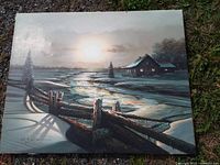 Front view of oil painting showing winter landscape scene and signature