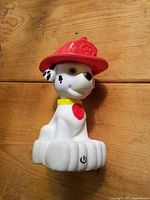 Front view of Paw Patrol Marshall night light showing full figure, helmet, collar, badge and power button on base