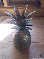 Full view of the brass pineapple container with lid in place