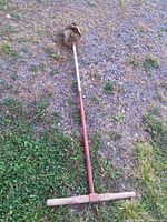 Full view of the manual post hole digger laid on ground