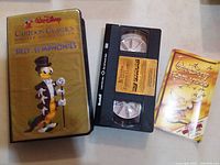 Front view of clamshell case, VHS cassette, booklet