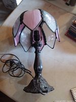 Full view of lamp with stained glass shade and cord