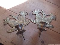 Front view of both brass pineapple candle sconces