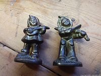Front view of both brass child violinist figurines