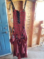 Full view of red tartan dress hanging, showing overall style and length