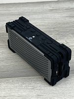 Angled view showing speaker grille and rugged casing