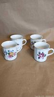 Group shot of all four floral porcelain mugs
