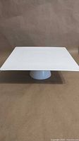 Front angled view of square pedestal cake plate