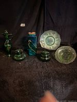 All six green and teal glass items arranged together