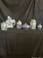 All seven blue-and-white porcelain pieces arranged on black background