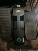 Top view of Cubii under-desk elliptical showing LCD display, resistance dial and both pedals