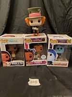 Front view of four Funko Pop figures, three boxed and one loose
