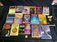 All eighteen paperbacks laid out in three rows, showing covers and condition