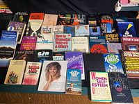 Overview of approximately 40 books on New Age, spirituality, self-help and related topics arranged on floor