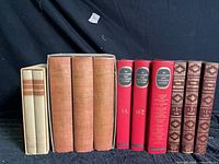 Front spines of 11 hardcover reference books arranged left to right