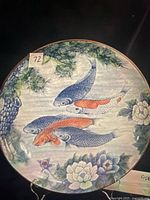 Front view of porcelain charger showing koi, pine, peony design