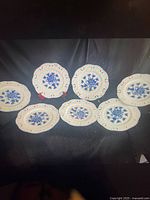 Seven blue floral porcelain plates with pierced rims