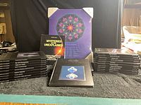 Front view shows two stacks of black Mysteries of the Unknown volumes flanking the Reader’s Digest book and a cover plate image