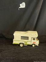 Side view of white Tonka Winnebago die-cast camper RV toy with green W graphics