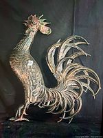 Full view of rooster sculpture showing material, finish, and overall condition