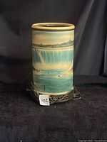 Front view of cylindrical Niagara Falls scenic electric lamp showing shade design, base, and attached cord