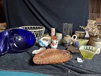 Group shot showing all decorative items in lot on dark cloth backdrop
