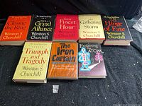 Front view of all eight hardcover books with dust jackets arranged side by side