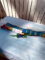 Packaged multicolour kite and separate line winder on table