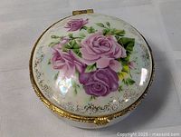 Top view of round porcelain jewelry box with rose motif