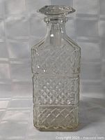 Full view of crystal decanter and stopper