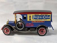 Left side view of Pepsi-Cola die-cast truck showing graphics and wheels
