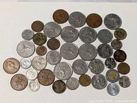 Full layout of approximately 39 British coins