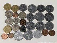 Overall view of entire coin lot laid out on white background