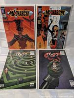 All four bagged comics laid out front covers visible