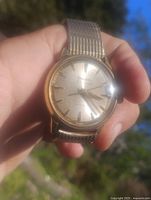 Front view showing Bulova dial, gold indices, gold-plated case and expansion band