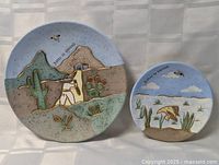 Front view of both terracotta plates showing relative sizes and designs