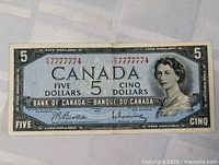 Full front view of the 1954 $5 banknote showing serial number, portrait, denomination, and signatures.