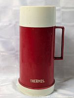 Front view red Thermos bottle with cream cap and base