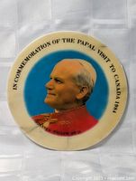 Front view of round marble slab showing portrait and inscription