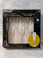 Front of Occasions box showing six clear plastic champagne flutes