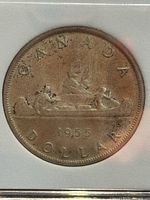 Reverse of 1955 Canadian silver dollar showing CANADA DOLLAR legend and Voyageur canoe design
