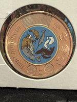 reverse side of coin showing colored Inuit Nunangat design inside 2x2 holder
