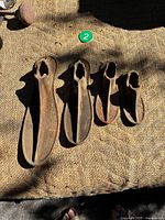 Top view of four cast iron shoe lasts showing arched uppers