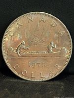 Reverse of 1976 Canada Voyageur dollar coin showing canoe design