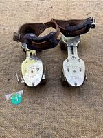 Pair of roller skates showing overall condition, straps, wheels