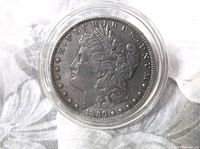 Obverse of 1880 Morgan dollar in capsule