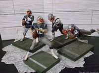 Four Patriots action figures on turf bases